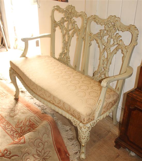 Georgian style carved and painted two-seater settee of serpentine form